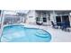 Screened-in pool area with outdoor seating at 109 Grosvenor Loop, Davenport, FL 33897