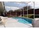 In-ground pool within a screened enclosure at 109 Grosvenor Loop, Davenport, FL 33897