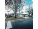 Neighborhood street view of homes with well-manicured lawns, driveways, and mature trees at 109 Grosvenor Loop, Davenport, FL 33897