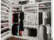 Organized walk-in closet with custom shelving for clothes and shoes at 11327 Ledgement Ln, Windermere, FL 34786