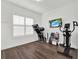 Bright exercise room with wood floors, a large window and modern exercise equipment at 11327 Ledgement Ln, Windermere, FL 34786