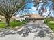 Charming single-story home featuring a tile roof, manicured landscaping, and a spacious two-car garage at 11327 Ledgement Ln, Windermere, FL 34786