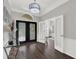 Bright foyer featuring hardwood floors and view to the office space at 11327 Ledgement Ln, Windermere, FL 34786