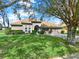 A charming one-story home with a manicured lawn, two-car garage and arched entryway at 11327 Ledgement Ln, Windermere, FL 34786