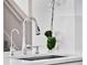 Close up of a chrome kitchen faucet and modern sink with white countertops at 11327 Ledgement Ln, Windermere, FL 34786