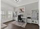 Bright home office with dark wood floors, custom built-in shelves and large windows at 11327 Ledgement Ln, Windermere, FL 34786