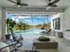 Screened outdoor patio with view of pool and waterfront at 11327 Ledgement Ln, Windermere, FL 34786