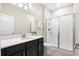 Modern bathroom featuring a vanity with solid surface countertop and a glass enclosed walk-in shower at 11381 Satire St, Orlando, FL 32832