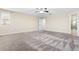 Spacious bedroom features plush carpeting, a ceiling fan, and neutral paint at 11381 Satire St, Orlando, FL 32832