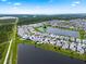 Aerial view of the community, showcasing the lakefront properties surrounded by lush green landscaping at 11381 Satire St, Orlando, FL 32832