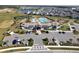 Aerial view of the community clubhouse featuring a beautiful pool, tennis court and playground at 11381 Satire St, Orlando, FL 32832