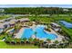 Aerial view of the community pool, tennis courts and clubhouse with mature trees at 11381 Satire St, Orlando, FL 32832