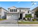 Beautiful two-story home with a three-car garage and professionally landscaped front yard at 11381 Satire St, Orlando, FL 32832