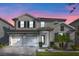 Charming two-story home featuring a three-car garage and beautiful landscaping at 11381 Satire St, Orlando, FL 32832