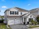 Beautiful two-story home featuring a three-car garage and manicured landscaping in a well-maintained community at 11381 Satire St, Orlando, FL 32832