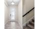 Inviting foyer featuring tile flooring, staircase and bright natural light at 11381 Satire St, Orlando, FL 32832