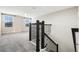 Hallway showcasing a carpeted staircase with black metal railing at 11381 Satire St, Orlando, FL 32832