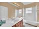 Bathroom showcasing a large mirror, single vanity and a shower-tub combo at 1195 Legendary, Clermont, FL 34711