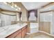 Traditional bathroom featuring double vanity, soaking tub, and glass enclosed shower at 1195 Legendary, Clermont, FL 34711