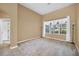 Bright bedroom featuring a large window with decorative curtains, plush carpeting, and ample natural light at 1195 Legendary, Clermont, FL 34711