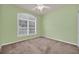 Bedroom with a large window allowing natural light and a ceiling fan at 1195 Legendary, Clermont, FL 34711