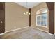 Elegant dining area with a chandelier, neutral carpet, a large window, and accent columns at 1195 Legendary, Clermont, FL 34711