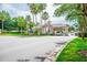 Community entrance featuring a vehicle gate, lush landscaping, and decorative lighting at 1195 Legendary, Clermont, FL 34711