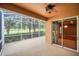 Screened lanai featuring a view of the backyard with lush landscaping and mature trees at 1195 Legendary, Clermont, FL 34711