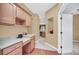 Home office area with custom cabinets, built-in desk, hardwood floors, and a view into the kitchen at 1195 Legendary, Clermont, FL 34711