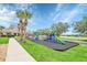 Community playground featuring a climbing wall, slides, and beautiful greenery at 1195 Legendary, Clermont, FL 34711