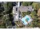 Aerial view of the swimming pool area with palm trees, sun loungers, pergolas, and green landscaping at 123 Avenham Drive, Deland, FL 32724