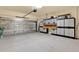 Spacious garage featuring a large garage door with added insulation and storage cabinets at 123 Avenham Drive, Deland, FL 32724