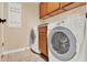 Laundry room with washer, dryer, cabinets and neutral paint at 123 Avenham Drive, Deland, FL 32724