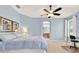 Light and airy main bedroom with blue walls, carpet flooring, ceiling fan, and ensuite bathroom at 123 Avenham Drive, Deland, FL 32724