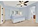 Spacious main bedroom boasts ceiling fan, carpet, and ensuite bathroom access at 123 Avenham Drive, Deland, FL 32724