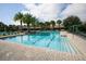 Resort-style pool area featuring palm trees, lounge chairs, umbrellas and clear blue water at 123 Avenham Drive, Deland, FL 32724