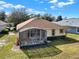 Aerial view of the home showcasing the screened lanai and well-kept lawn at 123 Avenham Drive, Deland, FL 32724