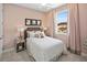 This bedroom features a bed with white bedding, a nightstand, neutral walls, carpet, and a window with curtains at 12471 Shipwatch St, Orlando, FL 32832