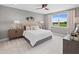 This primary bedroom features a tray ceiling, a ceiling fan, and two nightstands on each side of the bed at 12471 Shipwatch St, Orlando, FL 32832