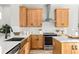 Modern kitchen with white countertops, stainless steel appliances, and wooden cabinets at 12471 Shipwatch St, Orlando, FL 32832