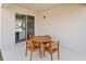 This patio features a wood table with four chairs, sliding glass door and neutral colored concrete at 12471 Shipwatch St, Orlando, FL 32832