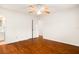 Bedroom with wood floors, ceiling fan, and a glimpse into the adjacent bathroom at 1307 Lindenwood Ln, Winter Park, FL 32792