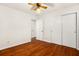 Bedroom featuring hardwood floors, a closet, and a ceiling fan for added comfort at 1307 Lindenwood Ln, Winter Park, FL 32792