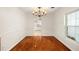 Bright and open dining area featuring hardwood floors and a view into the kitchen at 1307 Lindenwood Ln, Winter Park, FL 32792