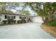 Beautiful home exterior with a two-car garage and a long driveway at 1307 Lindenwood Ln, Winter Park, FL 32792