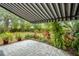 The paver patio has a striped awning and garden space with potted plants at 1307 Lindenwood Ln, Winter Park, FL 32792