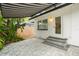 Paver patio with a black and white striped awning and lush greenery at 1307 Lindenwood Ln, Winter Park, FL 32792