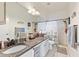 Well-lit bathroom featuring a large mirror, granite countertop, and a shower with a decorative curtain at 13101 Summerton Dr, Orlando, FL 32824