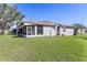 Wide shot of home's backyard and screened in patio at 13101 Summerton Dr, Orlando, FL 32824