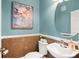 Stylish half-bathroom with blue walls and a cork accent wall at 1389 Chatfield Pl, Orlando, FL 32814